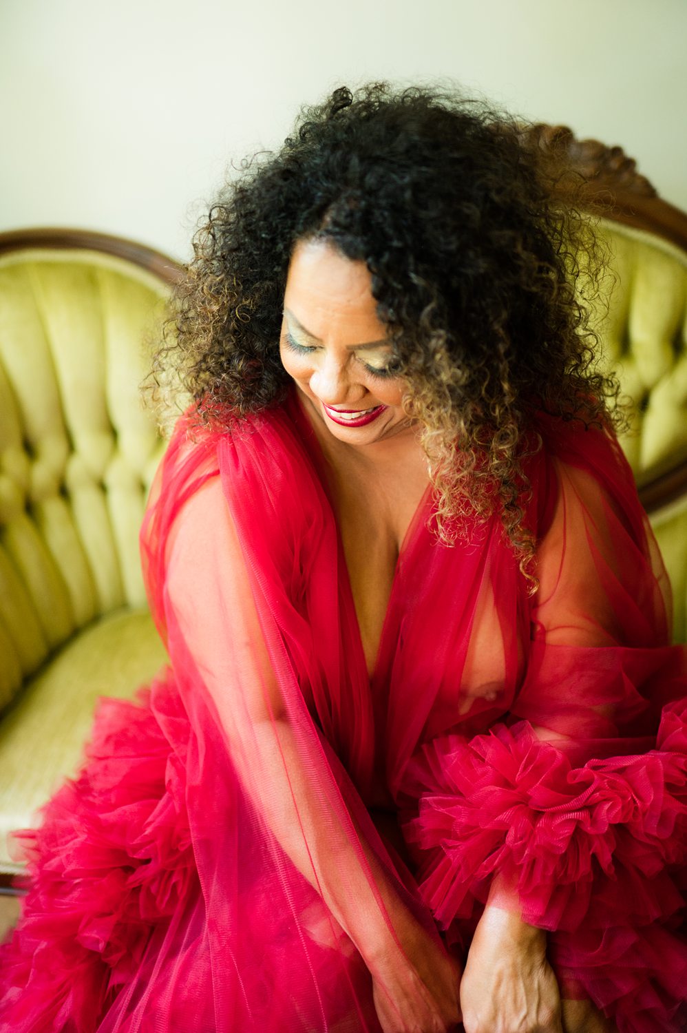 beautiful 50-year-old african american women smiles and laughs in her kalamazoo boudoir photos