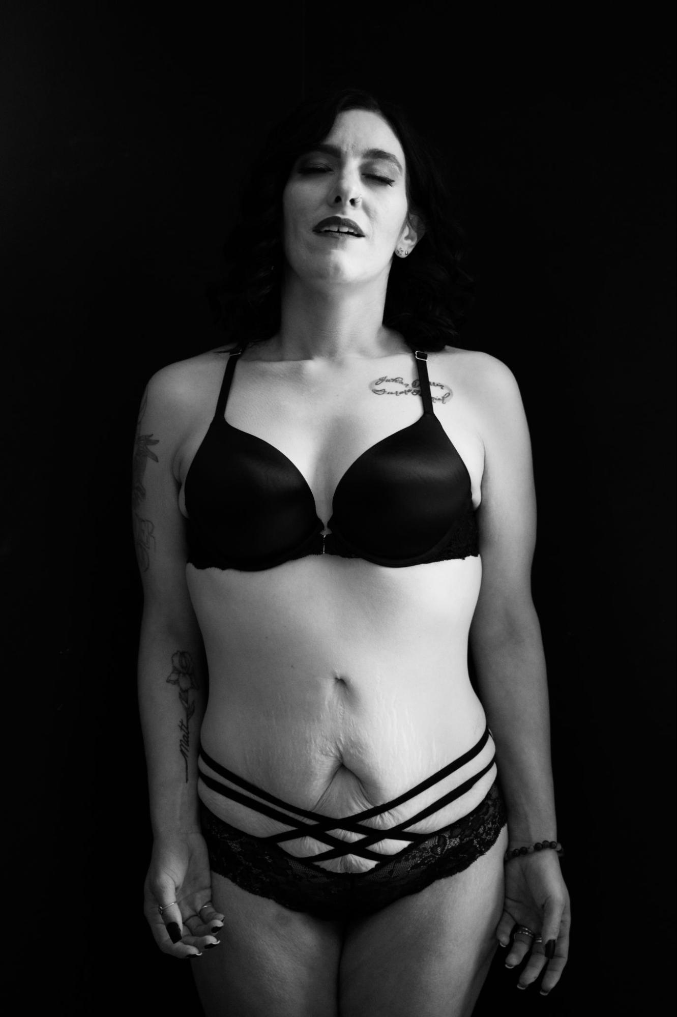 Emotive photo of woman in black lingerie during empowering boudoir session with Betsy McCue Pictures.