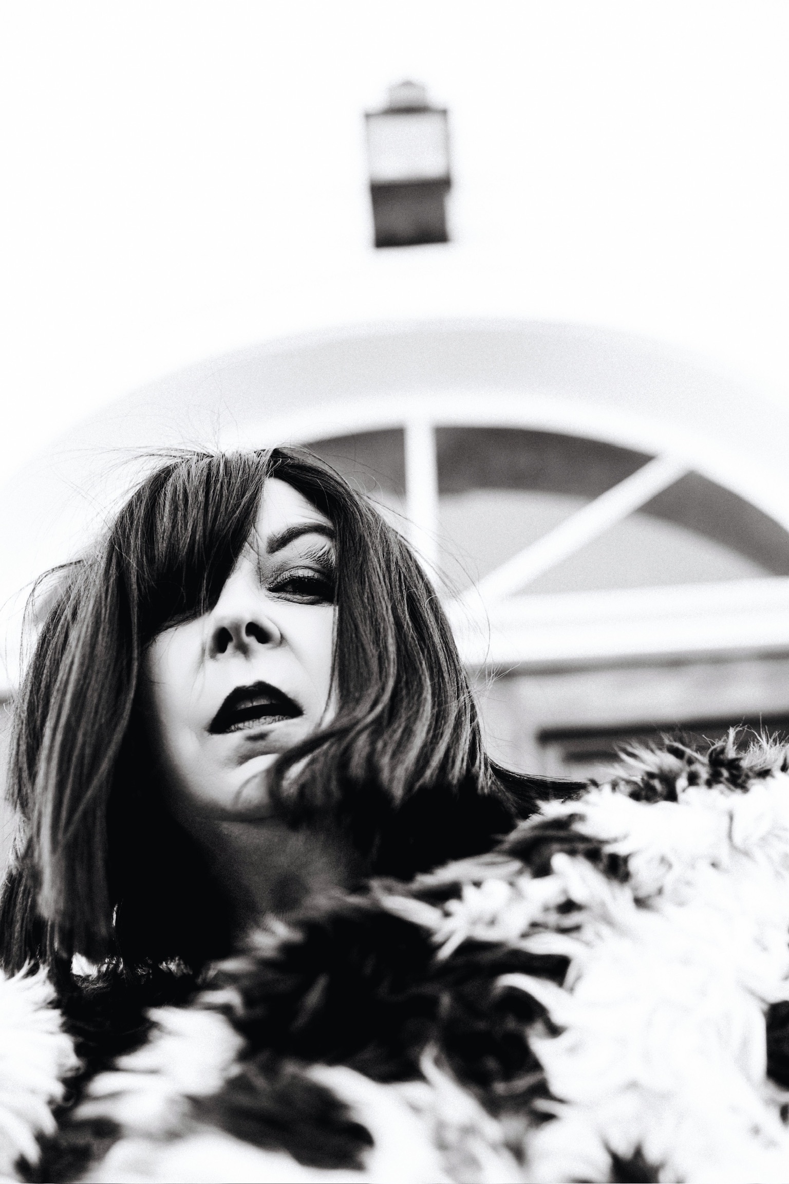 Betsy McCue Gibson, award-winning international intimate boudoir editorial photographer in Kalamazoo Michigan, photographed in black-and-white wearing fur coat.