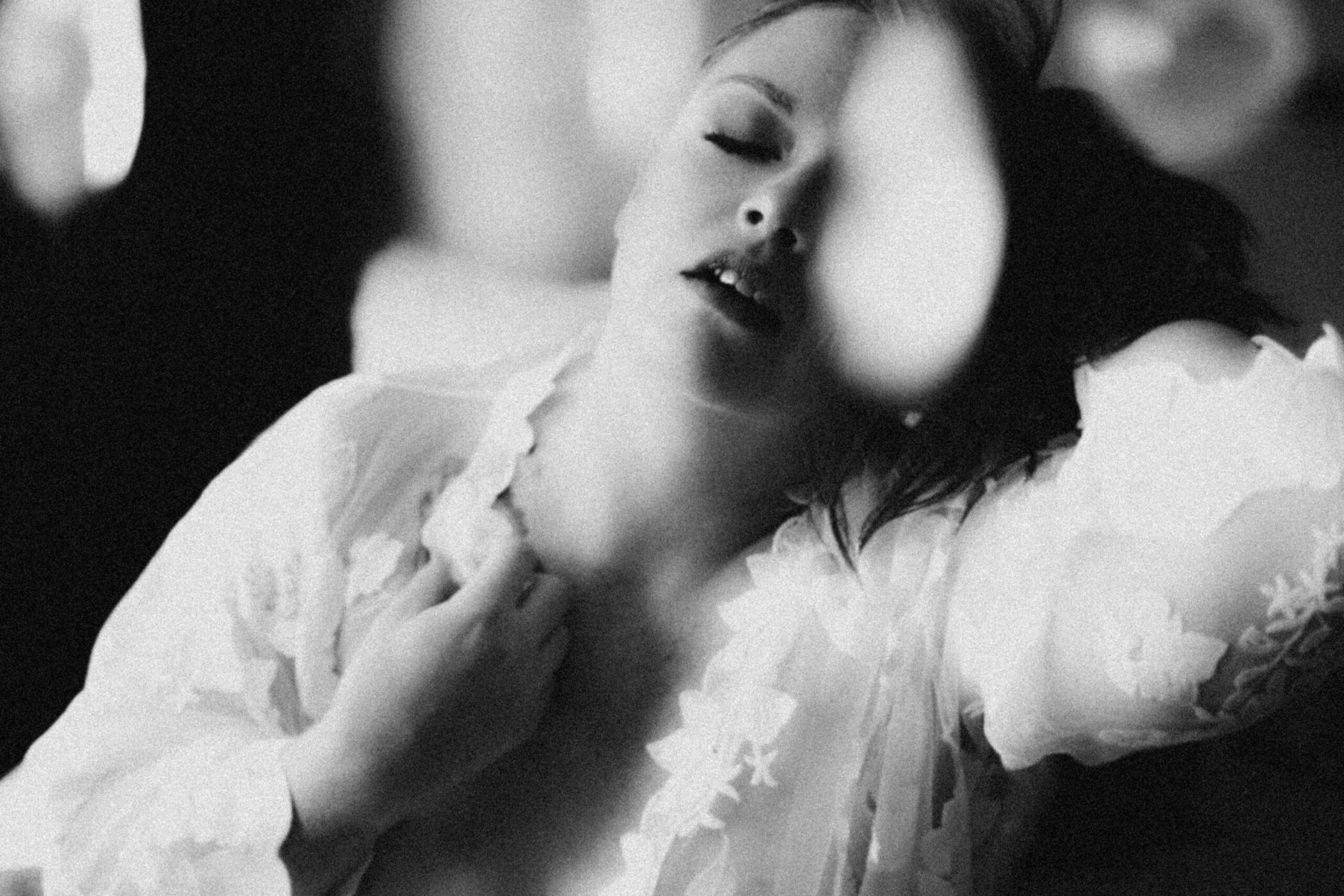 Award-winning luxury boudoir photography in Kalamazoo artistic black and white photo of woman posing with eyes closed
