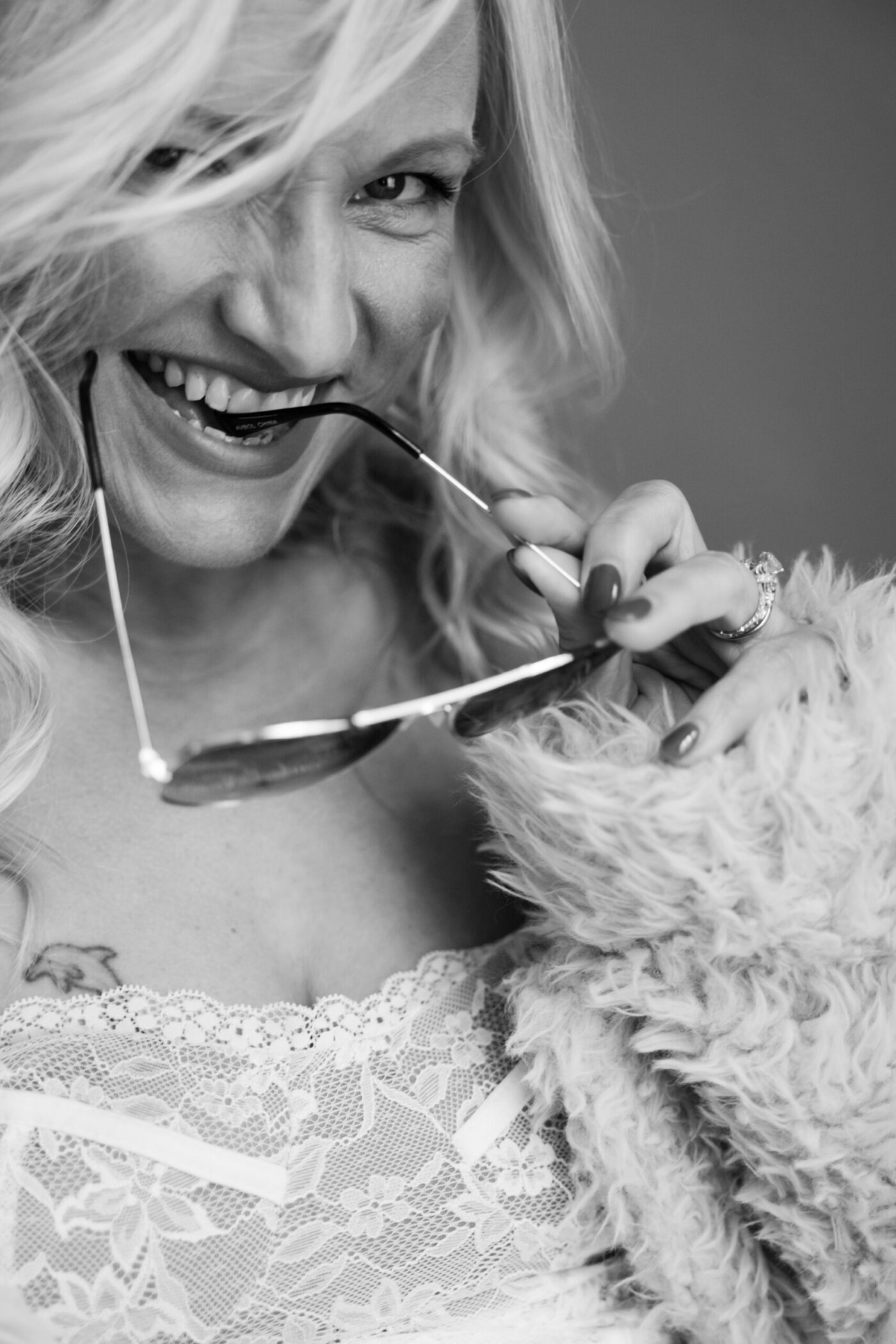 Glowing confident woman over 40 during fine art photography session in Michigan studio, finding empowerment in her journey