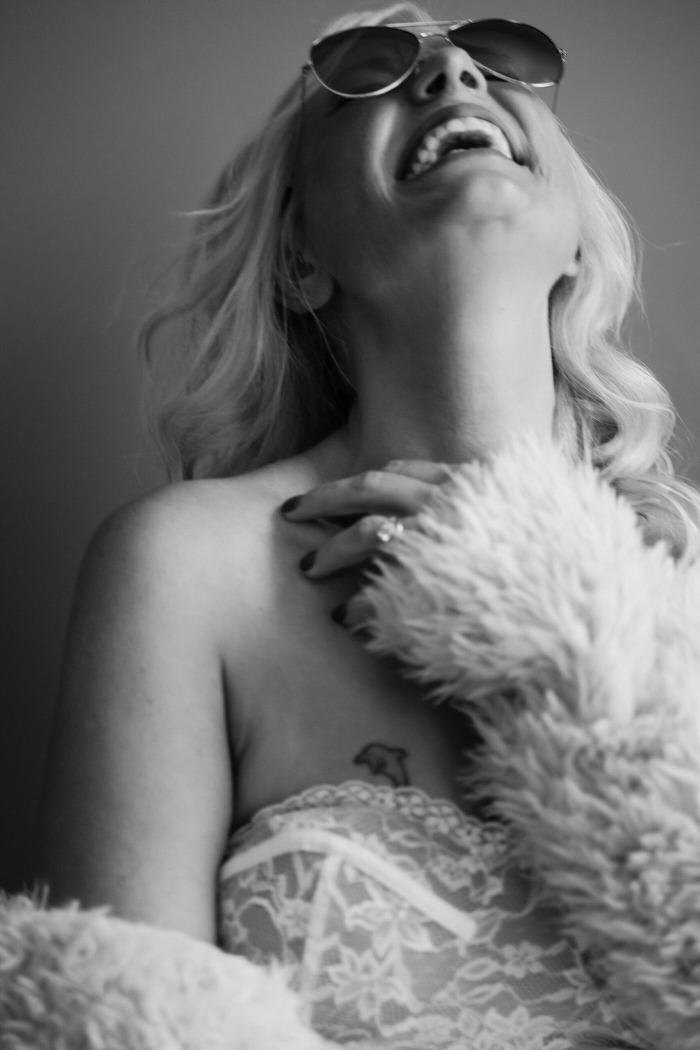 Stunning 40-something woman confidently posing during editorial boudoir photoshoot, discovering empowerment through midlife transition