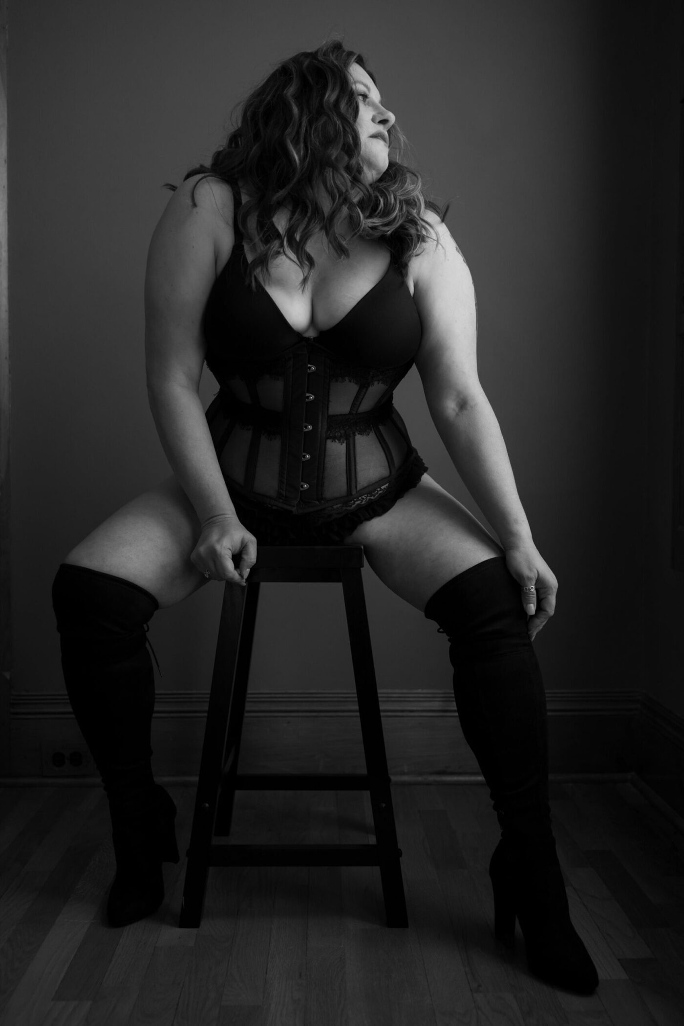 Empowered woman in her 40s during fine art boudoir photography session, radiating confidence while navigating perimenopause in Kalamazoo studio