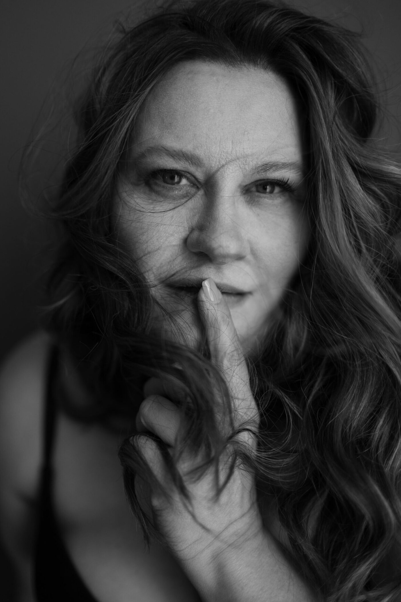 Radiant woman over 40 during confidence-building editorial photography session in Kalamazoo, embracing empowerment and beauty through perimenopause